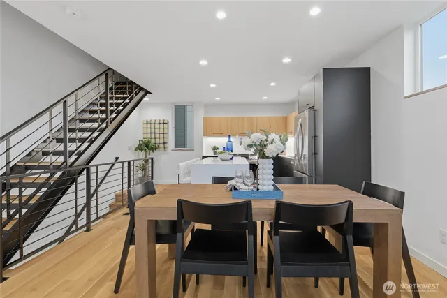 a dining room with furniture a rug and wooden floor