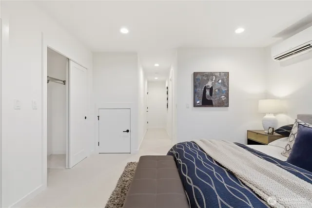 a bedroom with bed and night stand