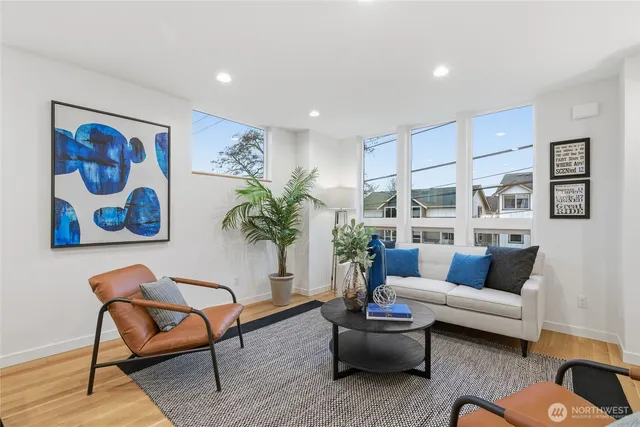 a living room with furniture and a potted plant
