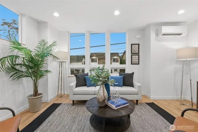 a living room with furniture potted plant and a table