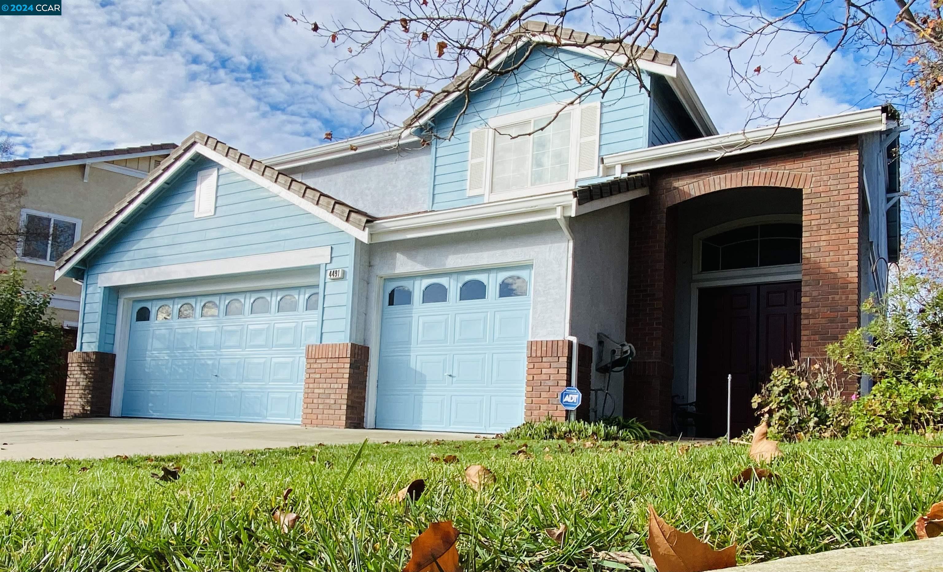 4491 Sparrow Court Dublin, CA 94568 - Photo 1 of 1 a front view of a house with a yard and garage