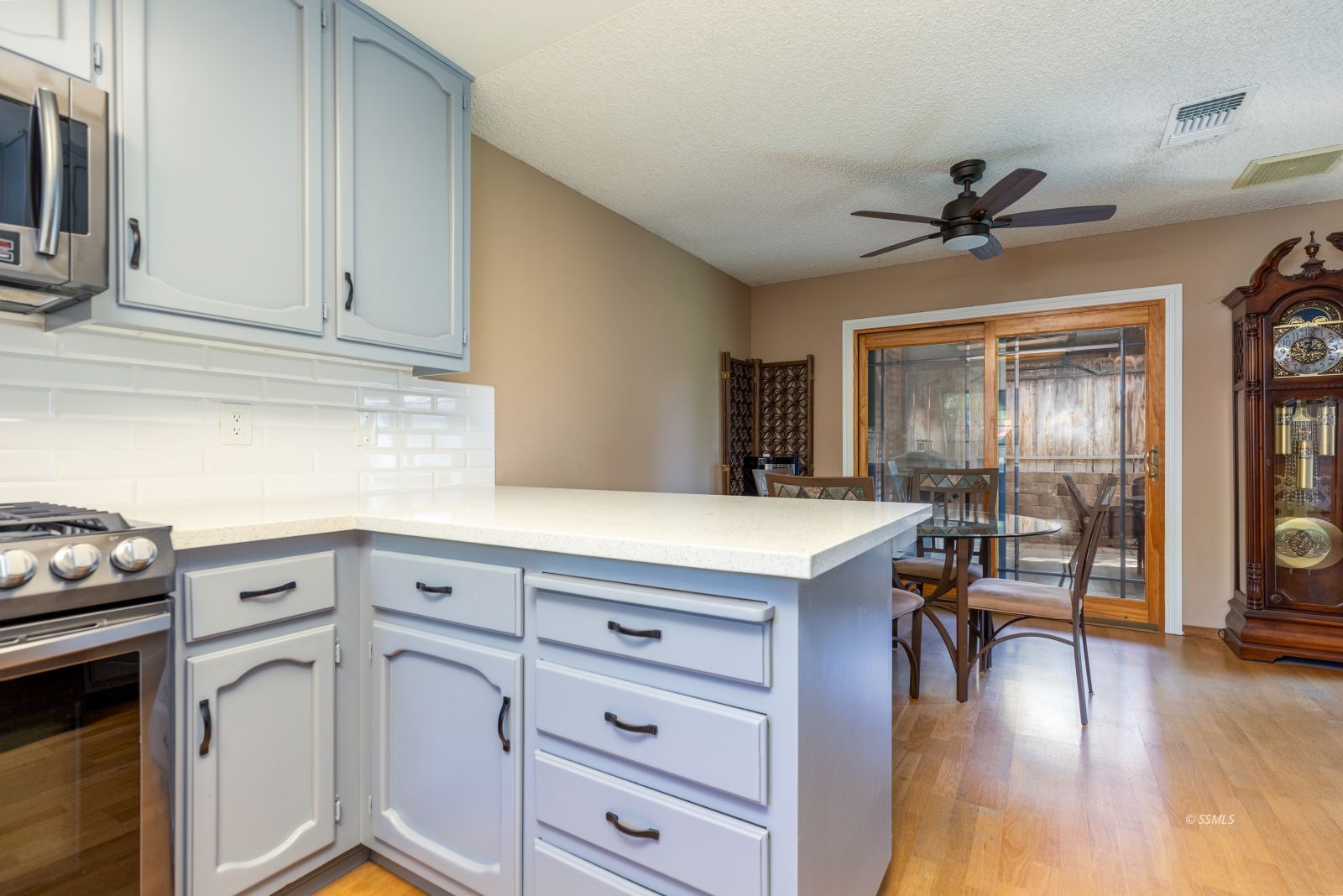 213 Washington Way Ridgecrest, CA 93555 - Photo 11 of 25 a kitchen with a refrigerator a stove cabinets and wooden floor