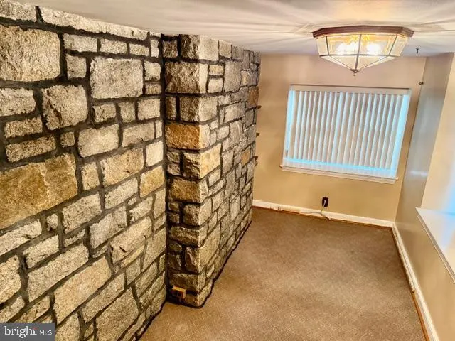 a view of an empty room with a fireplace