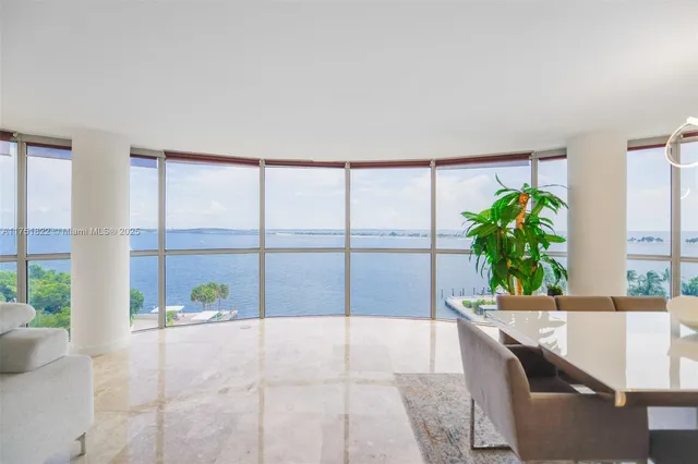 a living room with a large window and furniture