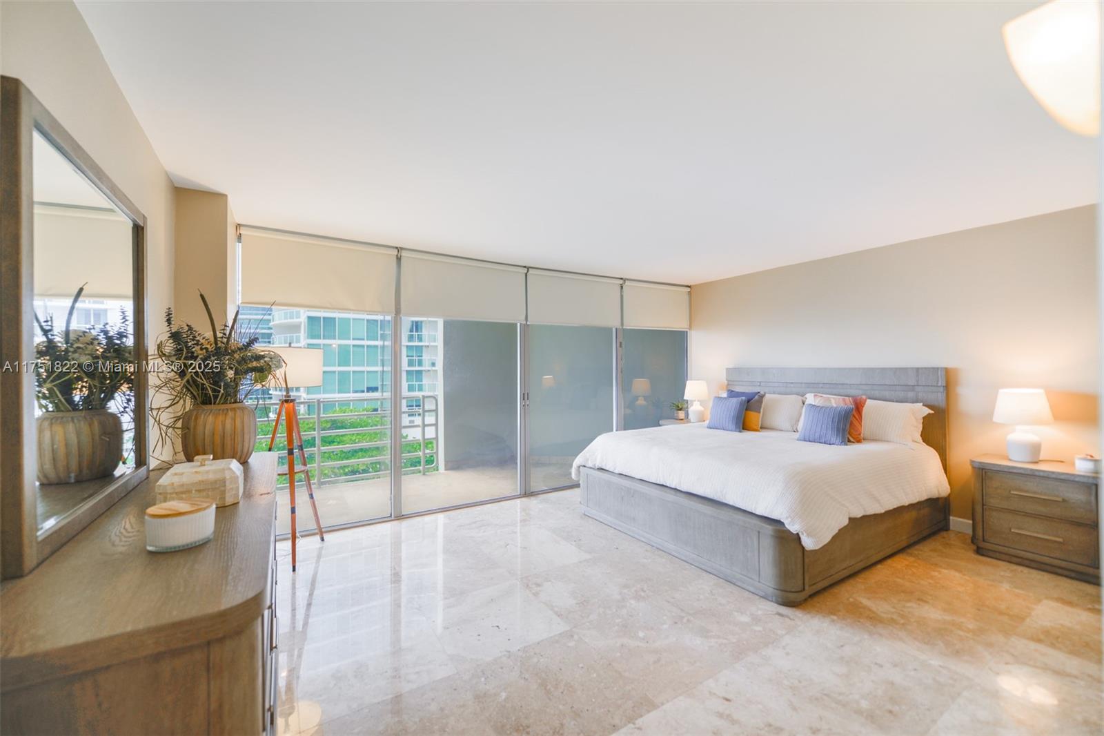 2025 Brickell Avenue, Unit 901 Miami, FL 33129 - Photo 12 of 49 a spacious bedroom with a bed and glass door