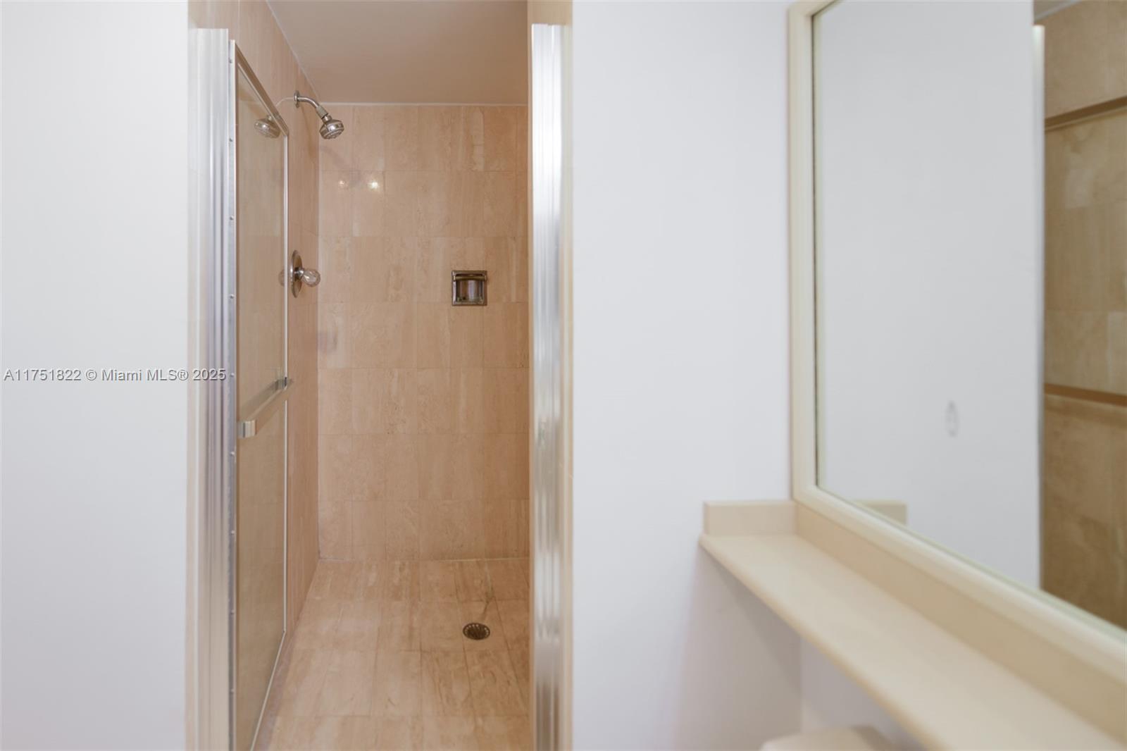 2025 Brickell Avenue, Unit 901 Miami, FL 33129 - Photo 18 of 49 a bathroom with a bathtub and shower