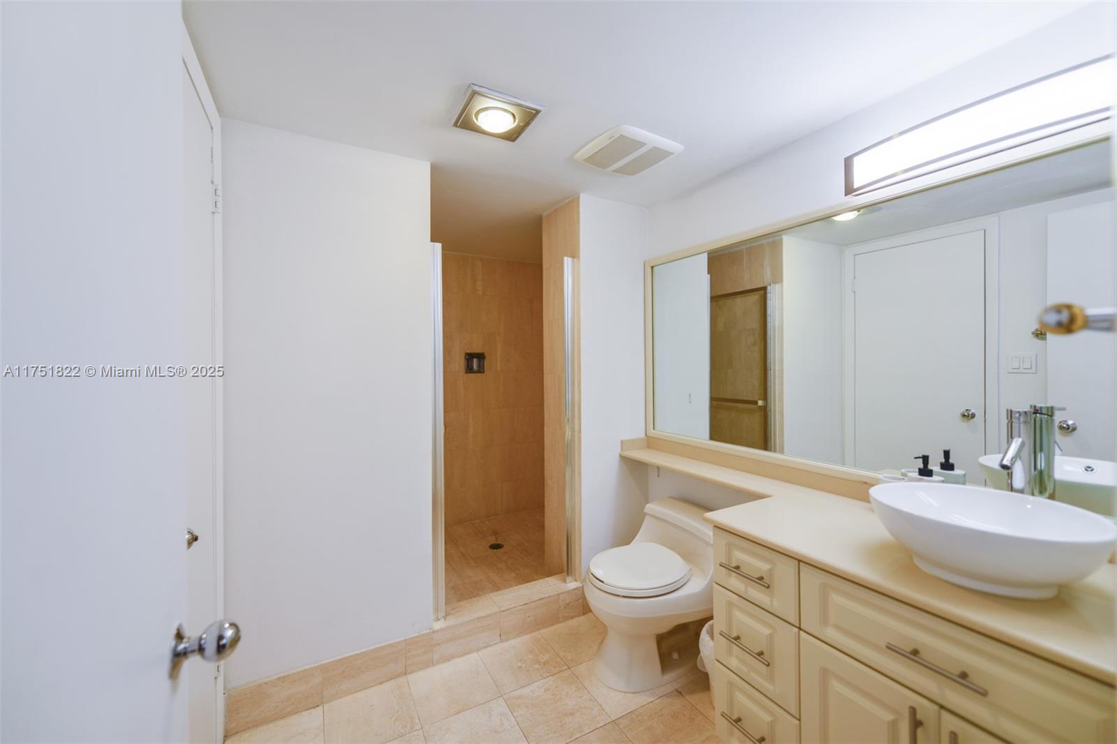 2025 Brickell Avenue, Unit 901 Miami, FL 33129 - Photo 19 of 49 a bathroom with a granite countertop sink toilet and shower