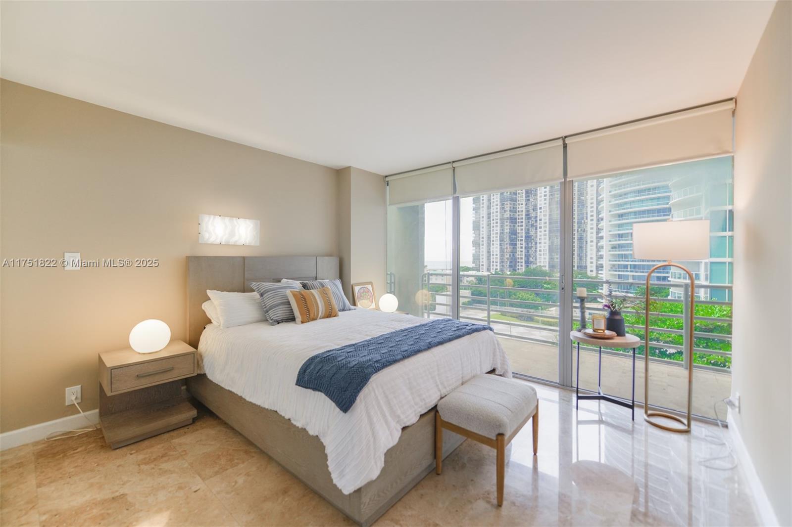 2025 Brickell Avenue, Unit 901 Miami, FL 33129 - Photo 22 of 49 a bedroom with a bed and large windows with outer view