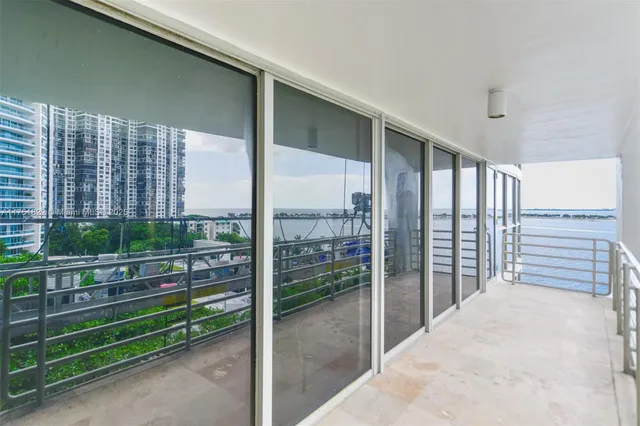 a view of a swimming pool with a patio and a garden