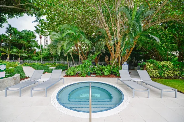 a view of a patio with a table and chairs and potted plants