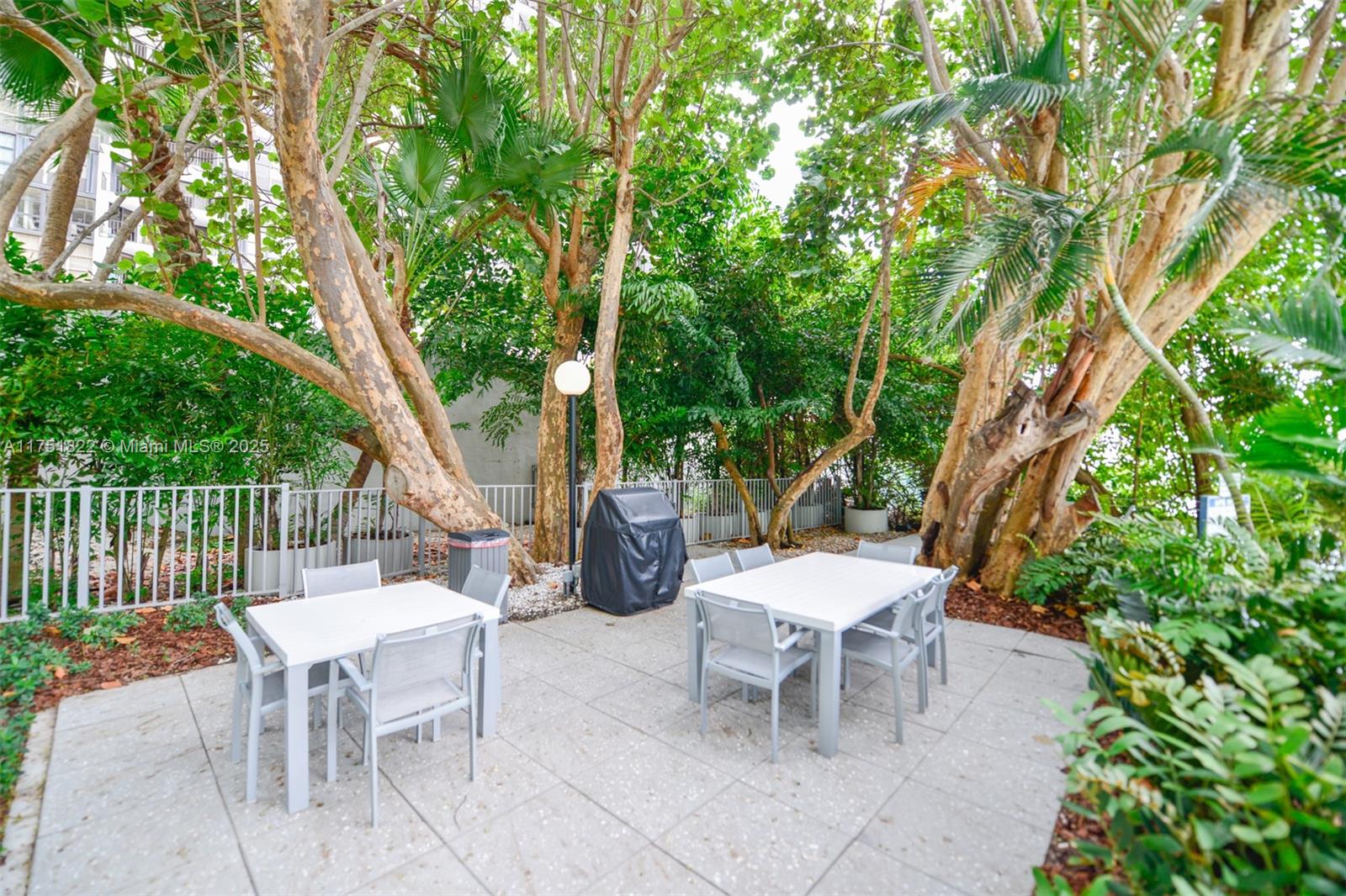 2025 Brickell Avenue, Unit 901 Miami, FL 33129 - Photo 29 of 49 a view of a patio with a table and chairs and potted plants