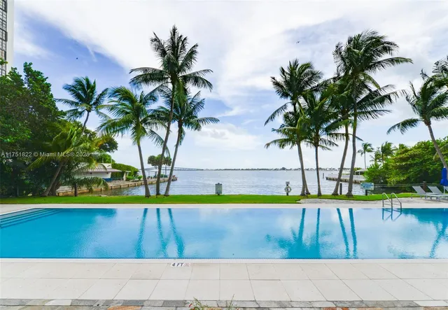 a view of a house with swimming pool and sitting area