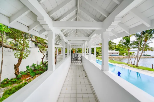 a living room with furniture and a pool table