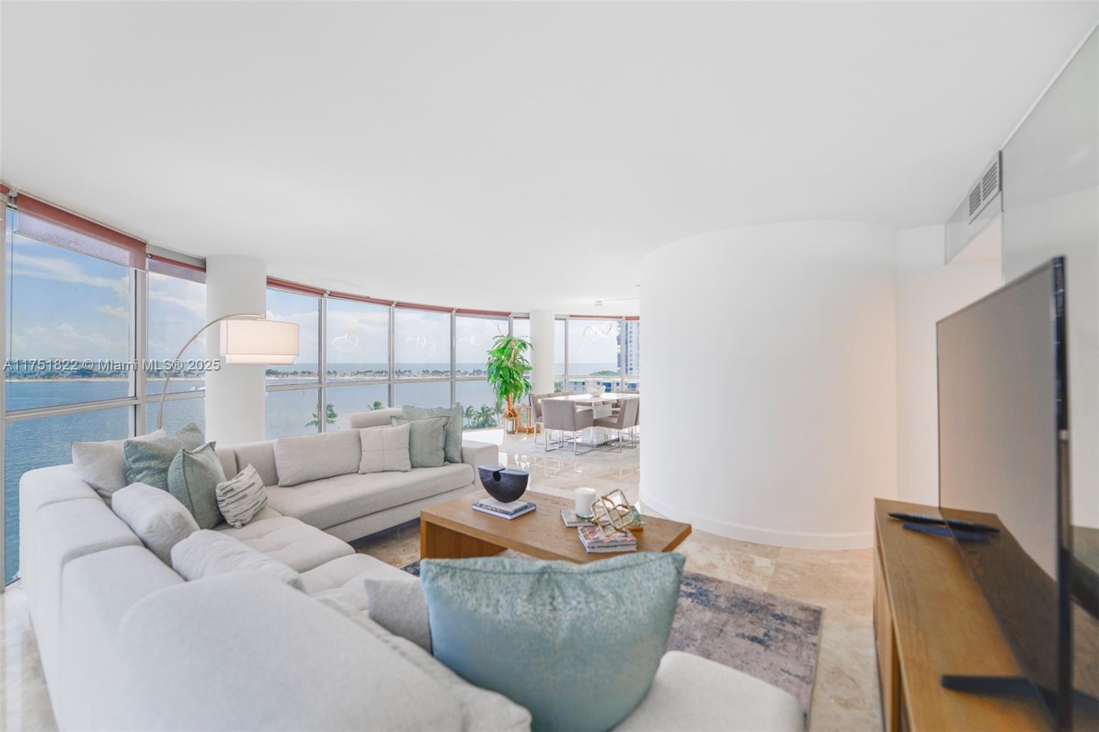 2025 Brickell Avenue, Unit 901 Miami, FL 33129 - Photo 5 of 49 a living room with furniture and a flat screen tv