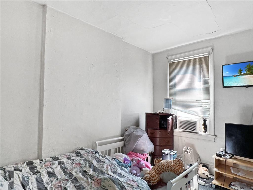 7347 Burton Street Pittsburgh, PA 15218 - Photo 18 of 31 a bedroom with a bed and flat screen tv