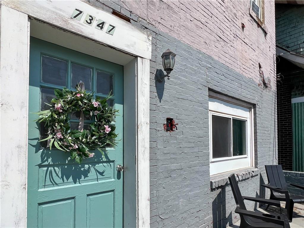 7347 Burton Street Pittsburgh, PA 15218 - Photo 2 of 31 a potted plant sitting in front of a house