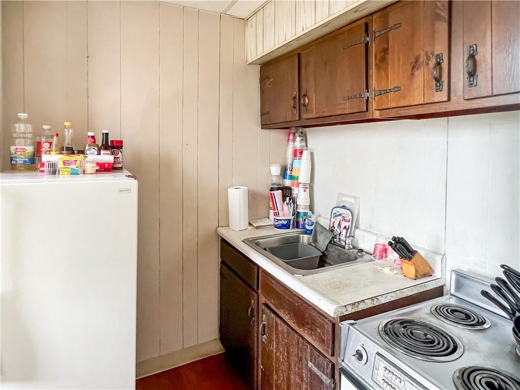 7347 Burton Street Pittsburgh, PA 15218 - Photo 23 of 31 a kitchen with stainless steel appliances granite countertop a sink stove and cabinets