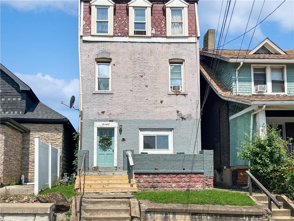 7347 Burton Street Pittsburgh, PA 15218 - Photo 31 of 31 a front view of a house with a yard
