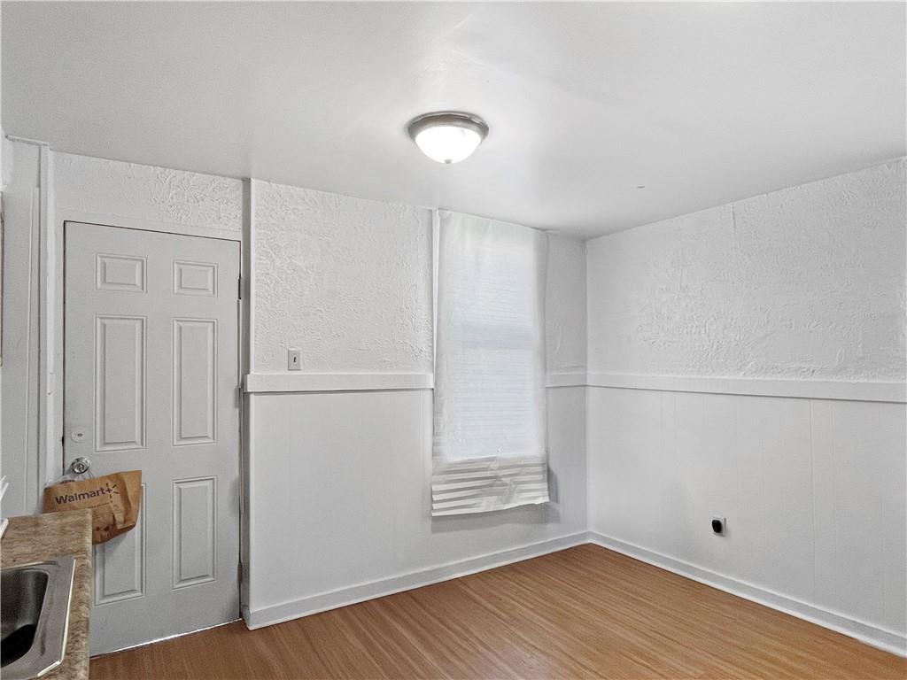 7347 Burton Street Pittsburgh, PA 15218 - Photo 9 of 31 an empty room with wooden floor and closet