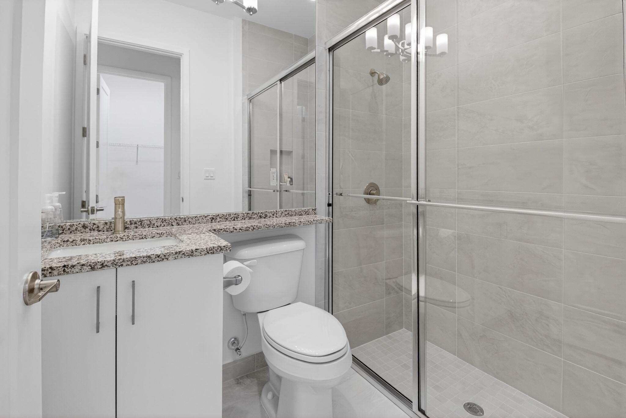 20370 Whistling Straits Way Boca Raton, FL 33434 - Photo 25 of 40 a bathroom with a granite countertop sink toilet and shower