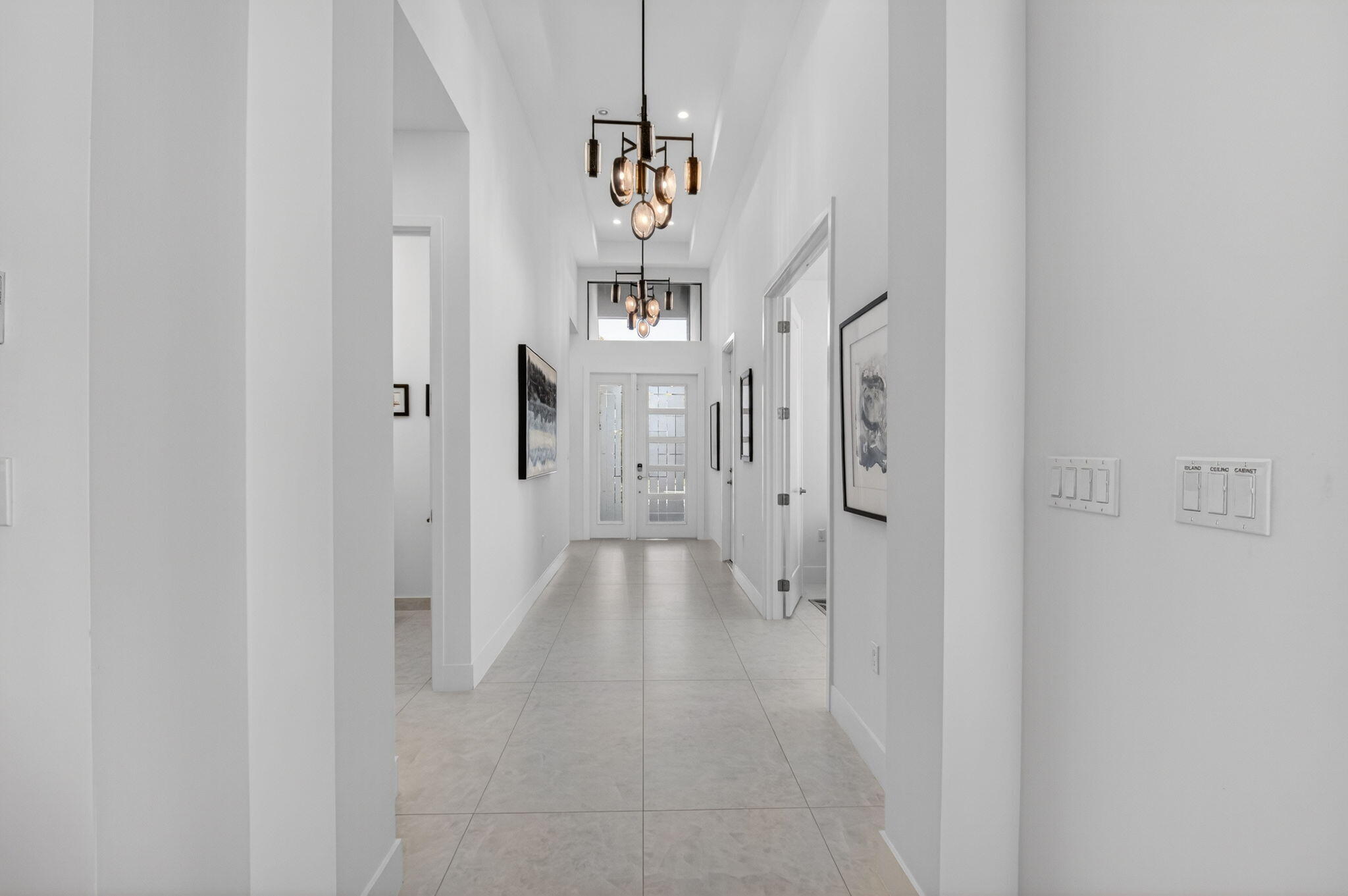 20370 Whistling Straits Way Boca Raton, FL 33434 - Photo 3 of 40 a view of a hallway with chandelier and glass door