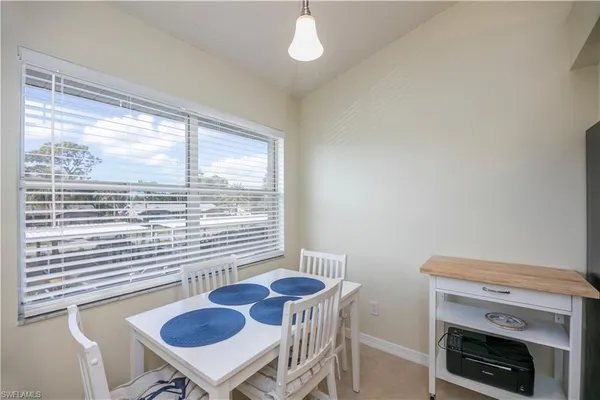 a view of a dining room with furniture window and outside view