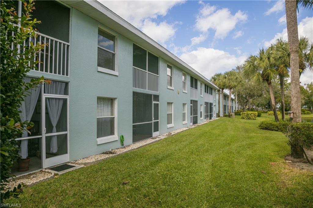 113 Wading Bird Circle, Unit W204 Naples, FL 34110 - Photo 9 of 17 a house view with a garden space