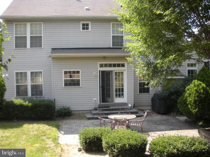 7633 Bear Forest Road Hanover, MD 21076 - Photo 14 of 24 a view of a brick house with plants and large windows