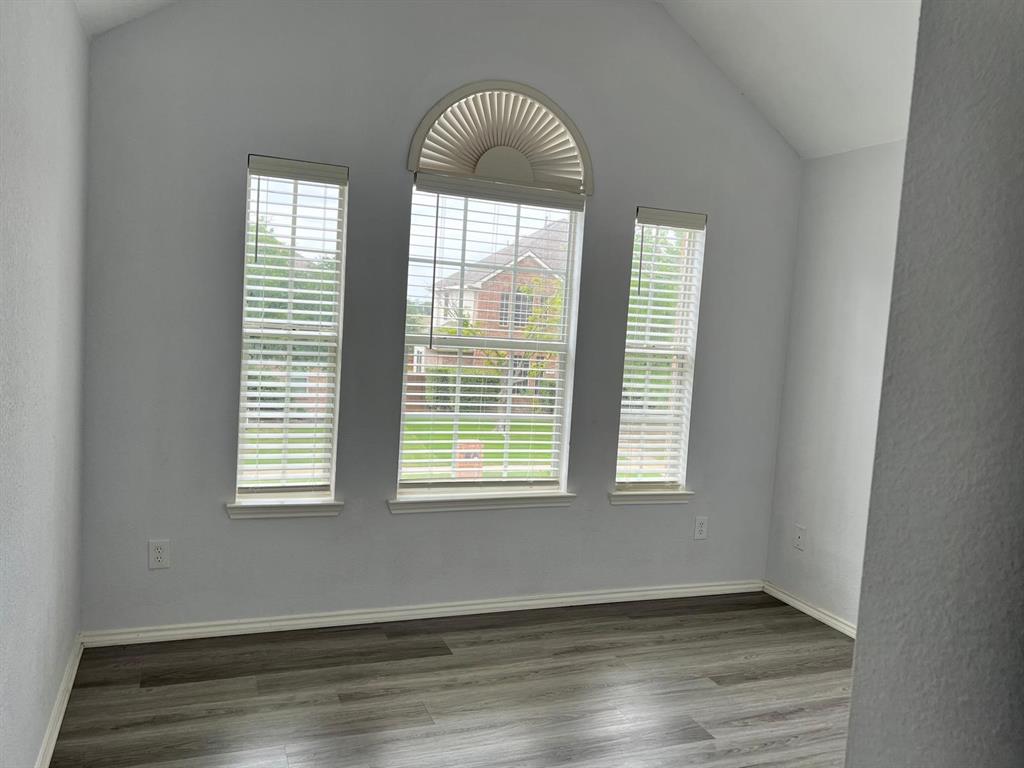 4312 Ridge Point Lane Plano, TX 75024 - Photo 2 of 16 an empty room with wooden floor and windows