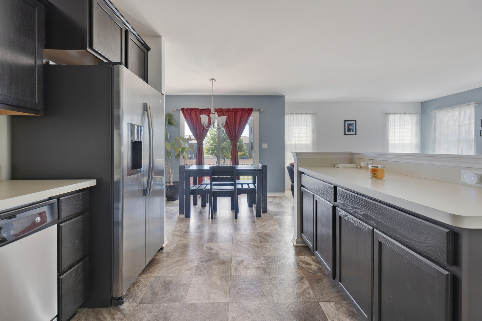 1651 Ruby Drive Pingree Grove, IL 60140 - Photo 13 of 26 a kitchen with stainless steel appliances granite countertop a refrigerator a sink a stove and a dining table with wooden floor