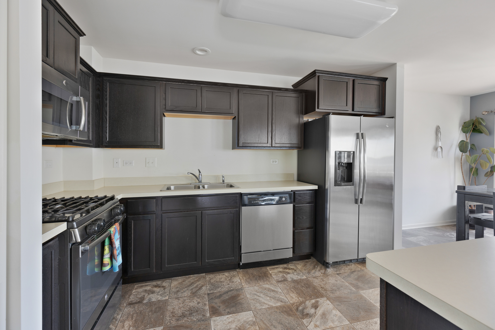 1651 Ruby Drive Pingree Grove, IL 60140 - Photo 14 of 26 a kitchen with stainless steel appliances granite countertop a stove a refrigerator and a sink