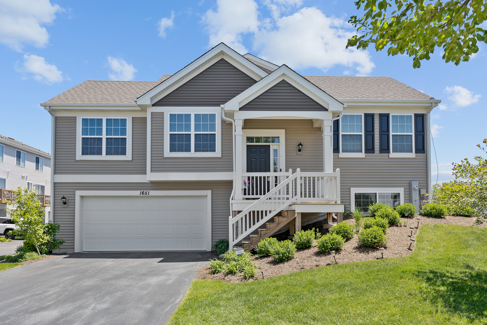 1651 Ruby Drive Pingree Grove, IL 60140 - Photo 2 of 26 a front view of a house with a yard