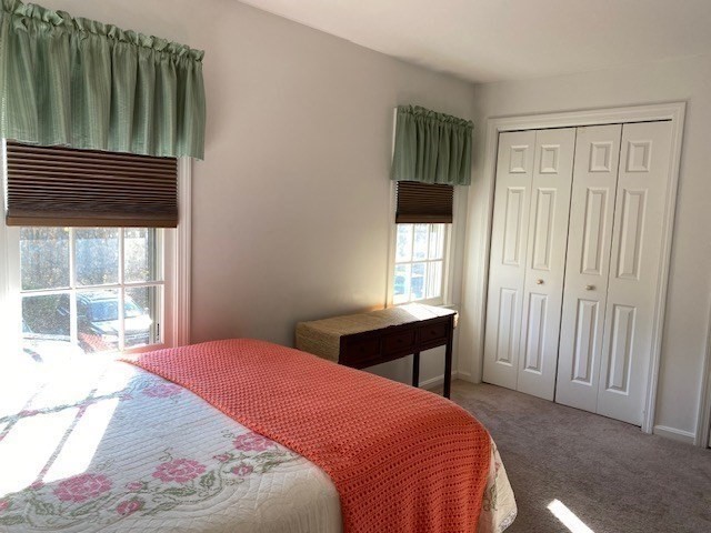 107 Center Depot Road, Unit C Charlton, MA 01507 - Photo 13 of 39 a bed sitting in a bedroom next to a window
