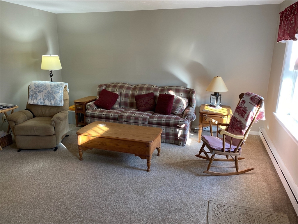 107 Center Depot Road, Unit C Charlton, MA 01507 - Photo 14 of 39 a living room with furniture and a lamp