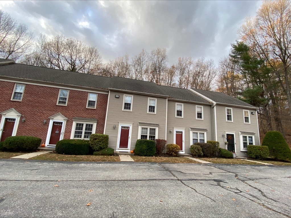 107 Center Depot Road, Unit C Charlton, MA 01507 - Photo 15 of 39 a front view of a house with a yard and garage