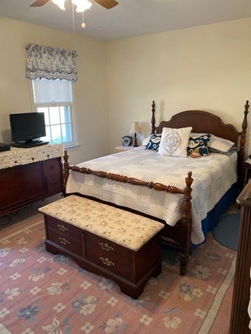 107 Center Depot Road, Unit C Charlton, MA 01507 - Photo 16 of 39 a bedroom with a bed and a flat screen tv