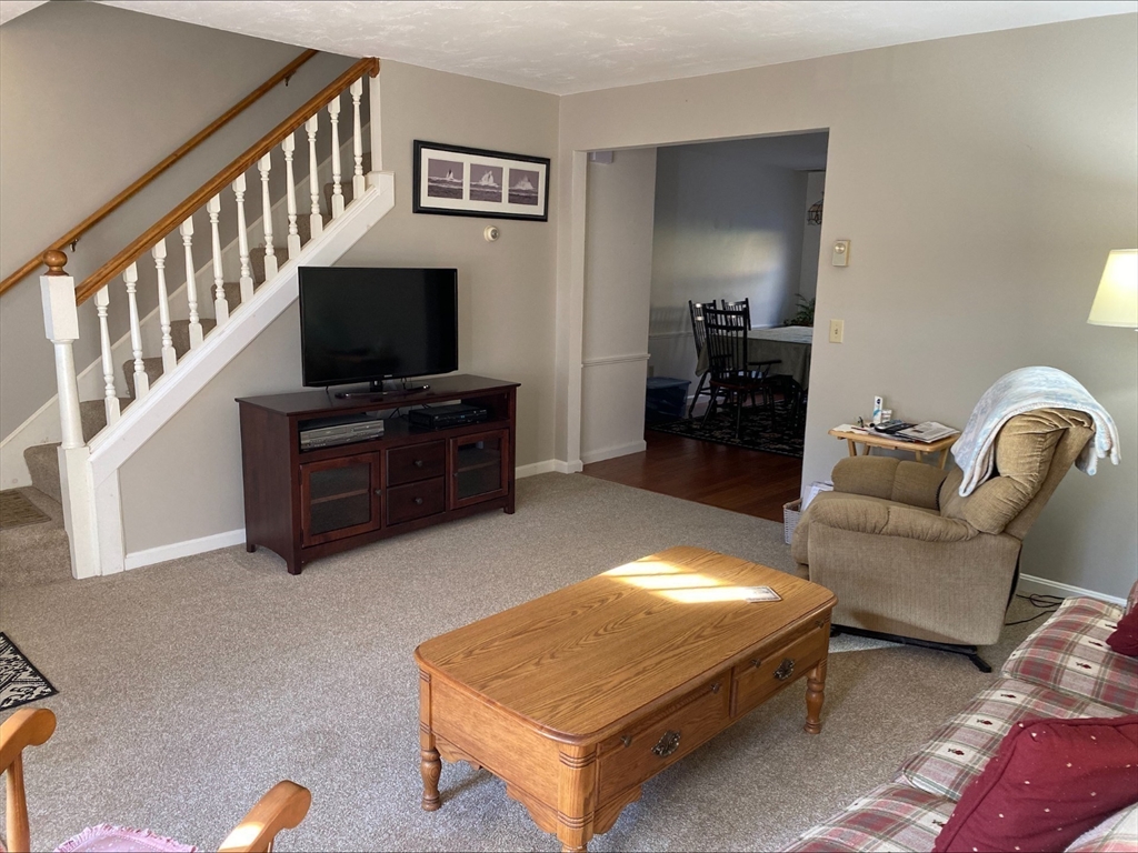 107 Center Depot Road, Unit C Charlton, MA 01507 - Photo 2 of 39 a living room with furniture and a flat screen tv
