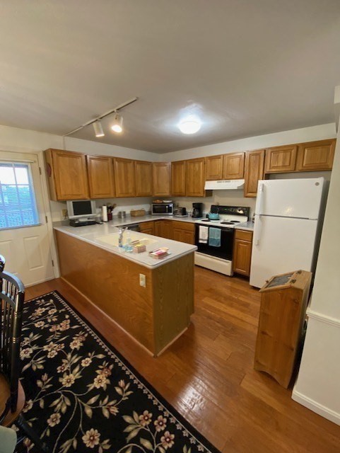 107 Center Depot Road, Unit C Charlton, MA 01507 - Photo 22 of 39 a kitchen with wooden cabinets and a stove top oven
