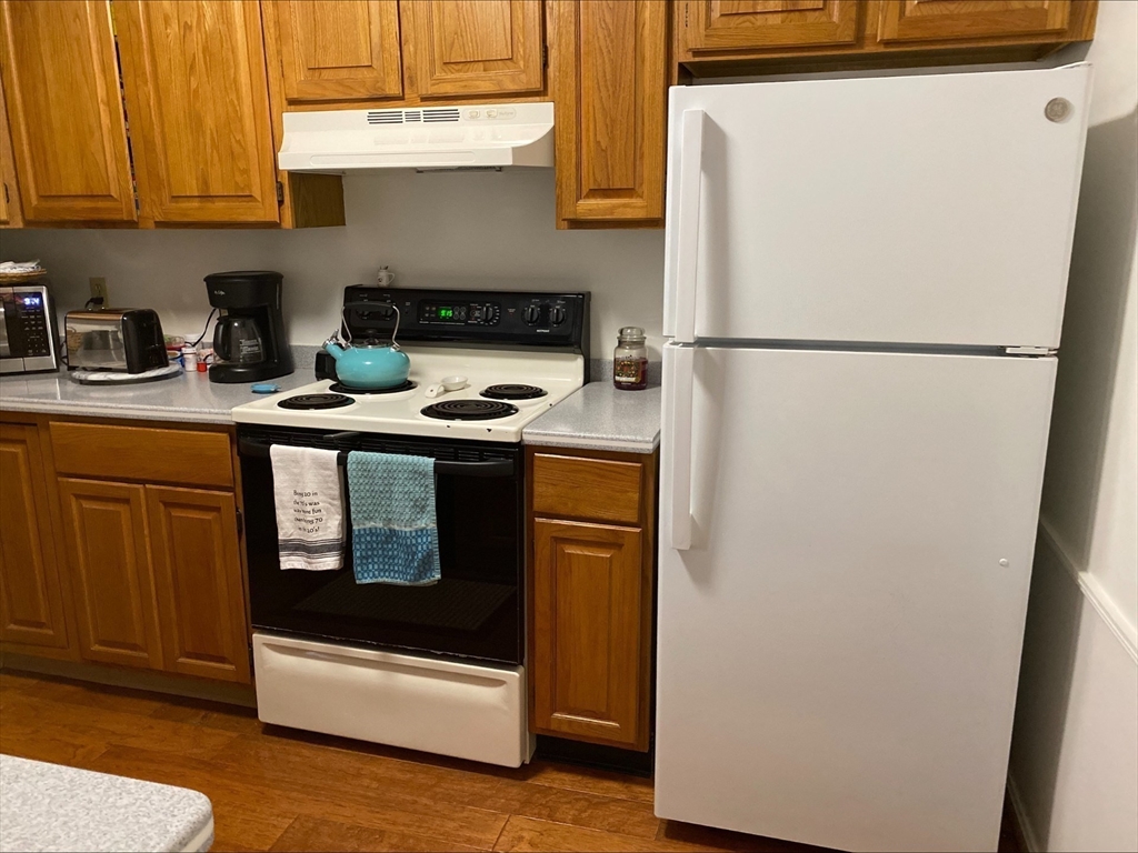 107 Center Depot Road, Unit C Charlton, MA 01507 - Photo 23 of 39 a kitchen with stainless steel appliances granite countertop a refrigerator a stove a sink and dishwasher