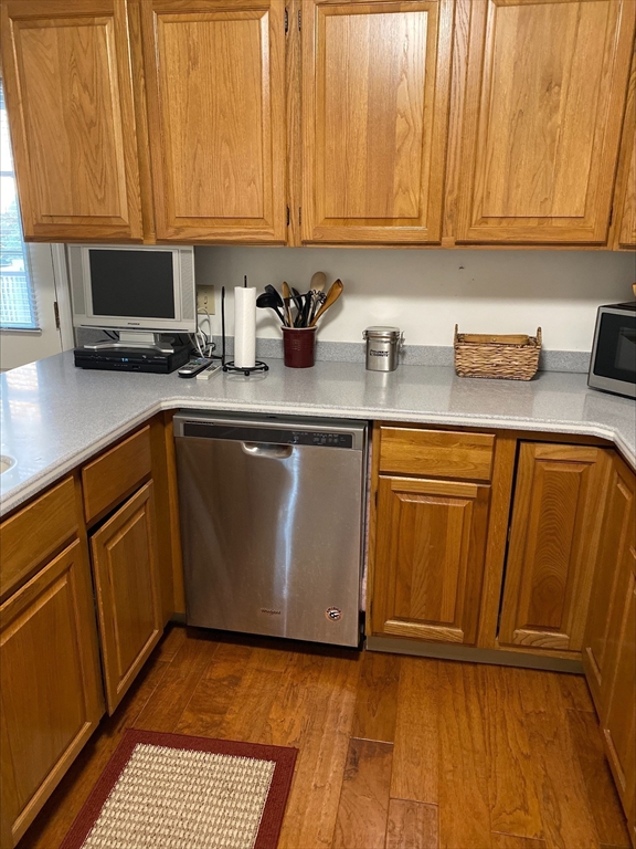 107 Center Depot Road, Unit C Charlton, MA 01507 - Photo 24 of 39 a kitchen with granite countertop wooden cabinets a sink and dishwasher