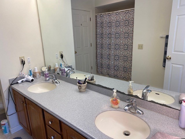 107 Center Depot Road, Unit C Charlton, MA 01507 - Photo 25 of 39 a bathroom with a double vanity sink and a mirror