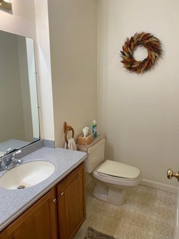 107 Center Depot Road, Unit C Charlton, MA 01507 - Photo 38 of 39 a bathroom with a granite countertop sink a toilet and a mirror