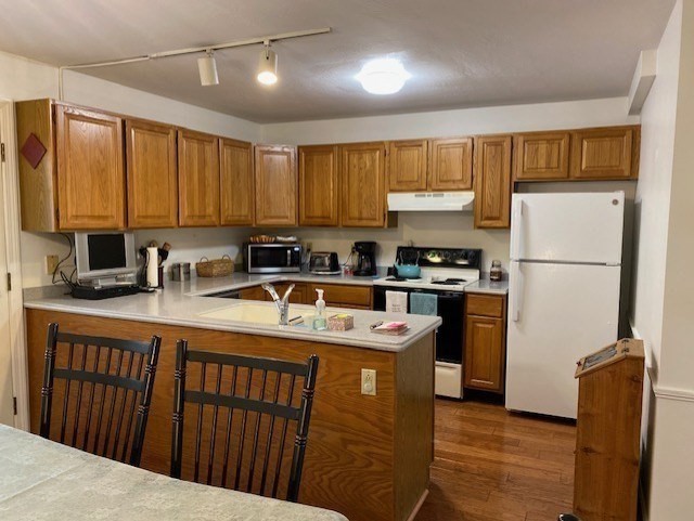 107 Center Depot Road, Unit C Charlton, MA 01507 - Photo 4 of 39 a kitchen with stainless steel appliances granite countertop a refrigerator a sink dishwasher a stove with wooden cabinets and floor