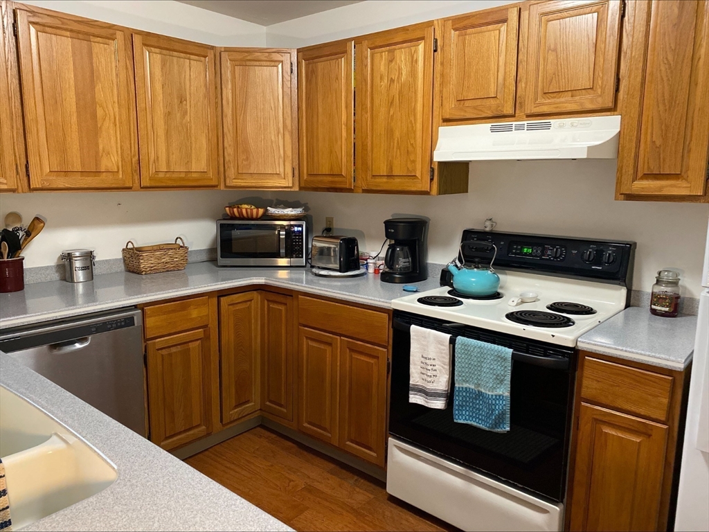 107 Center Depot Road, Unit C Charlton, MA 01507 - Photo 6 of 39 a kitchen with stainless steel appliances granite countertop a sink stove and cabinets