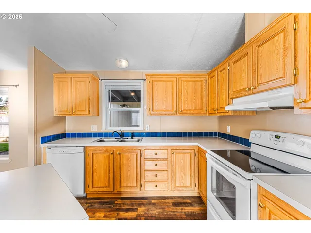 a kitchen with stainless steel appliances granite countertop a sink and cabinets