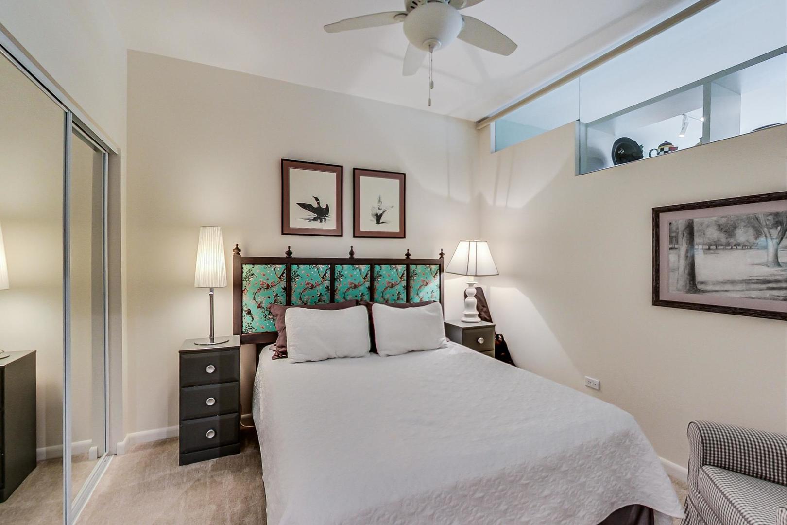 225 South Sangamon Street, Unit 809 Chicago, IL 60607 - Photo 11 of 34 a bedroom with a bed and a night stand