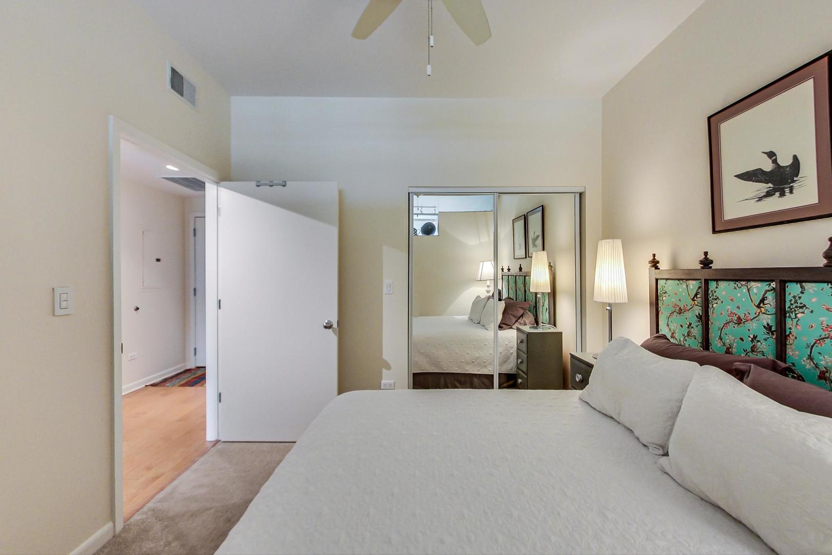 225 South Sangamon Street, Unit 809 Chicago, IL 60607 - Photo 13 of 34 a bedroom with a bed and a large mirror