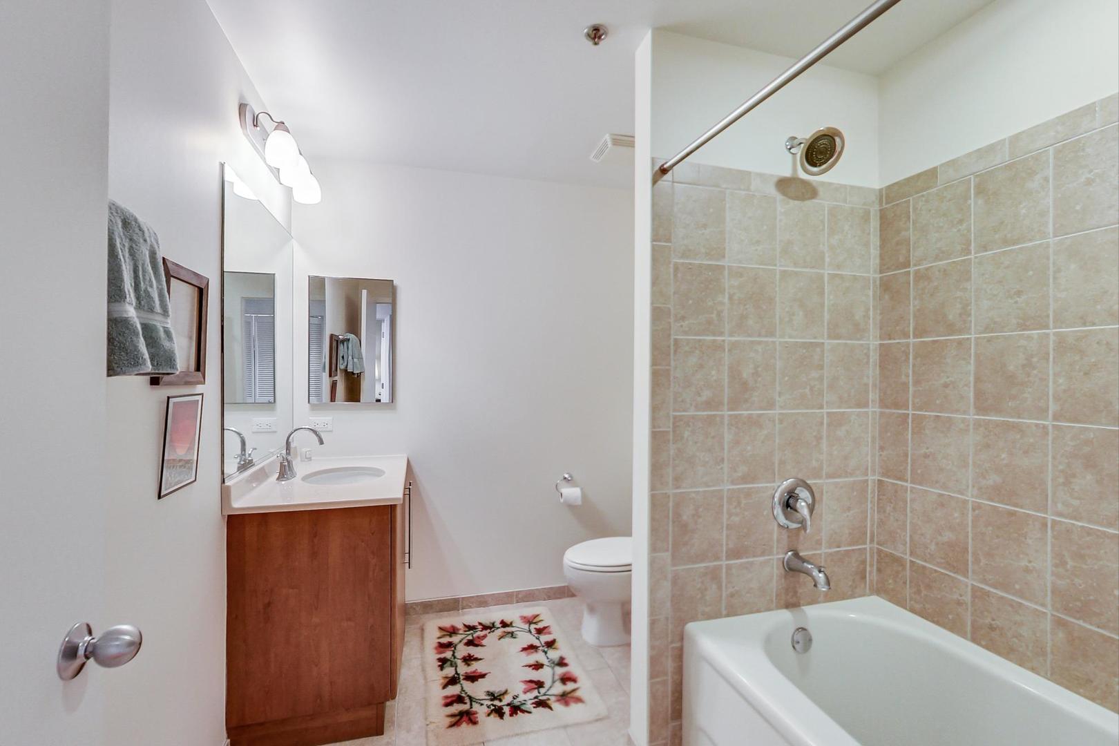 225 South Sangamon Street, Unit 809 Chicago, IL 60607 - Photo 14 of 34 a bathroom with a bathtub a sink and a shower