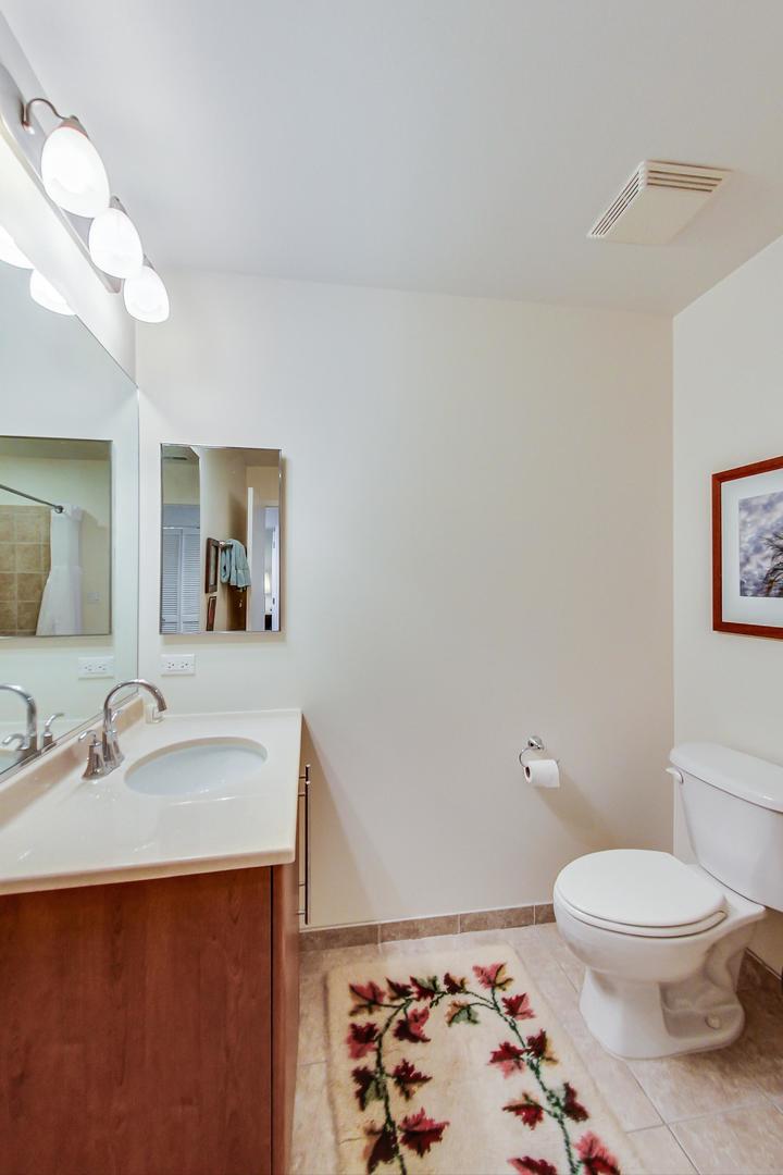 225 South Sangamon Street, Unit 809 Chicago, IL 60607 - Photo 16 of 34 a bathroom with a sink a toilet and mirror