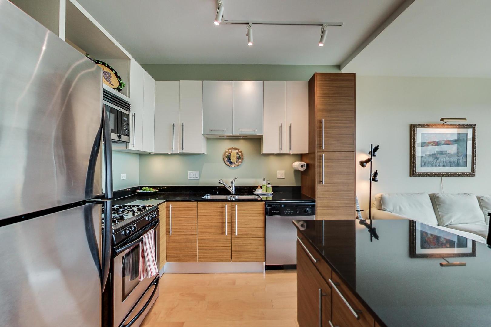 225 South Sangamon Street, Unit 809 Chicago, IL 60607 - Photo 22 of 34 a kitchen with stainless steel appliances granite countertop a sink stove and refrigerator